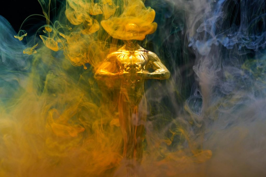 Historical Achievement! Filipino Educator Honored in New York for Remarkable Contribution to Teaching Science and Math 5 A golden statuette enveloped in vibrant yellow and blue smoke, symbolizing achievement and success.